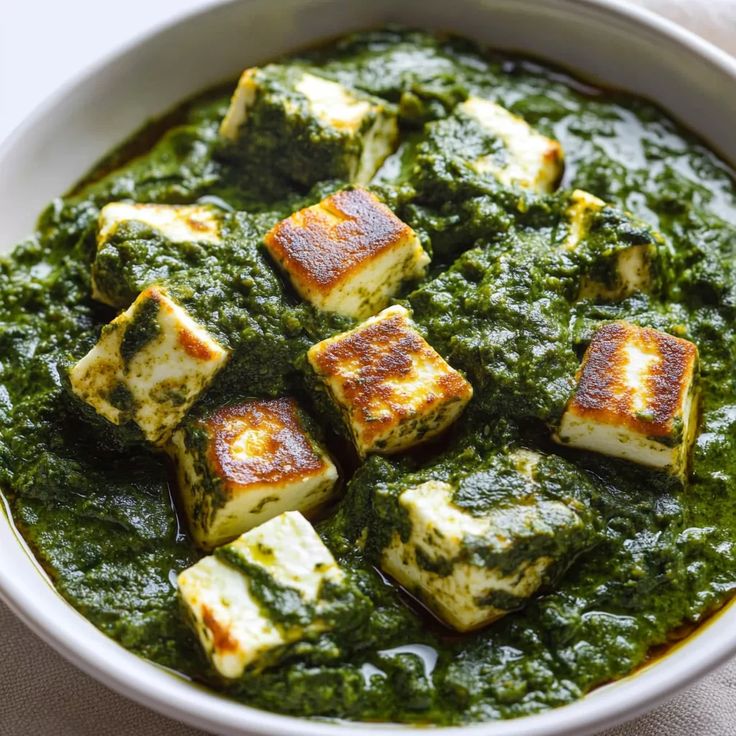 “Palak paneer curry with golden paneer cubes in spinach gravy”